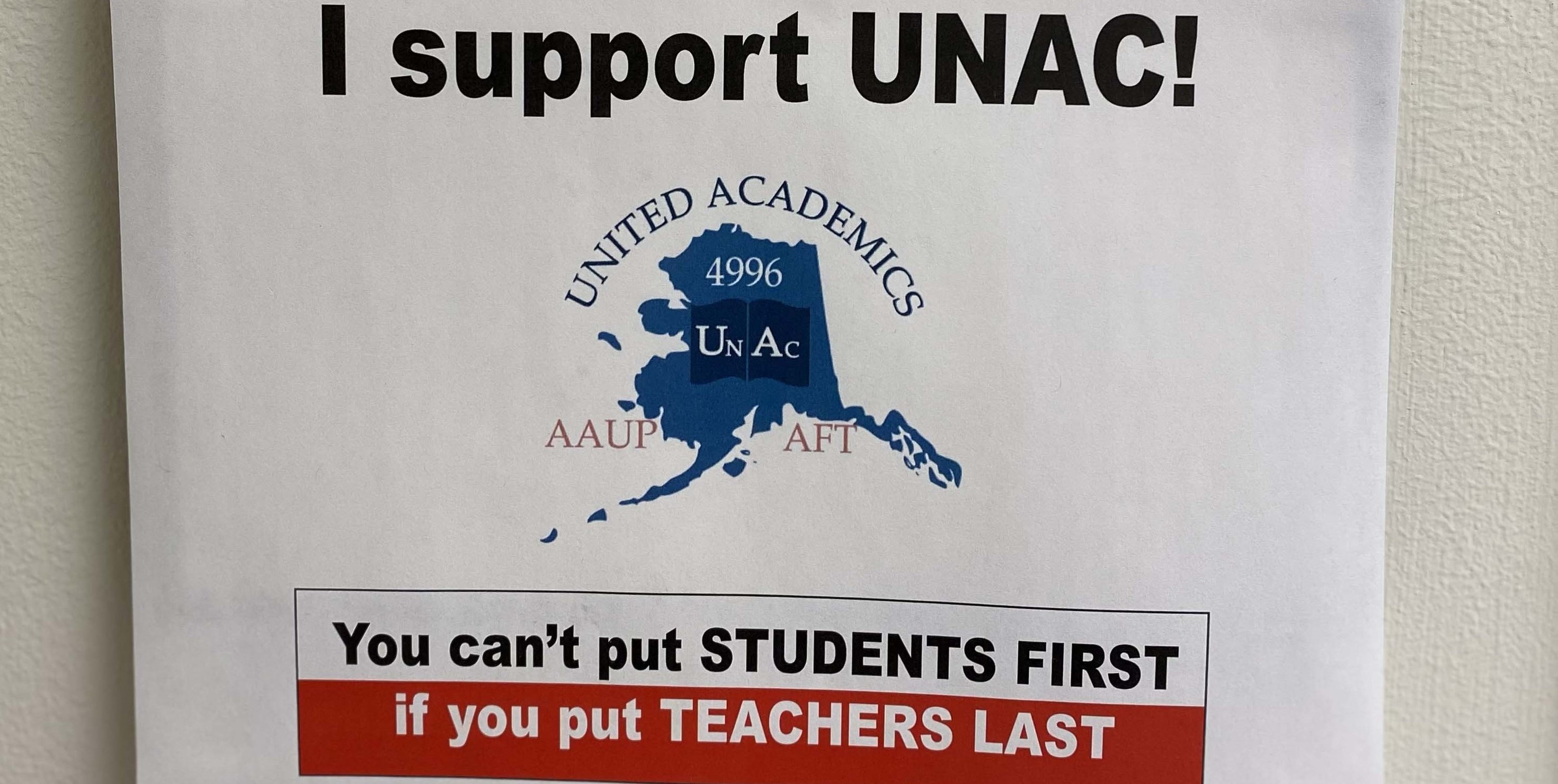 office door sign that says "I support UNAC! You can't put students first if you put teachers last"