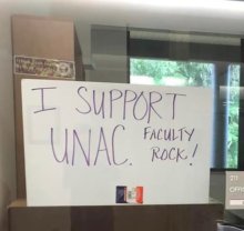 Photo showing a sign on an office window that says "I support UNAC. Faculty rock!"